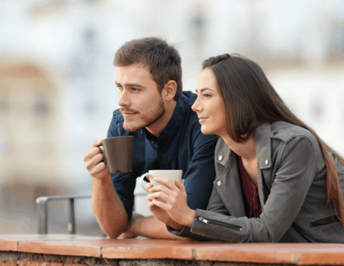 Illustration: A couple leaning on the safety wall at the top of a building, enjoying coffee and gazing out at the view.